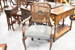 An early 20th Century bergere back armchair having moquette seat