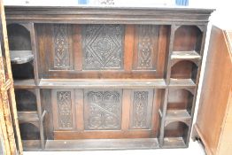 A period oak dresser back having carved decoration to panels, some damage to shelves. Width