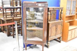 An early 20th century glazed mahogany corner display cabinet, with four internal shelves, long