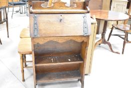 A late 19th or early 20th Century Arts & Crafts style bureau with bookshelf under, width approx.
