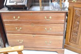A late Victorian mahogany three drawer bedroom chest, having tramline style design and brass drop