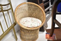 A vintage rattan peacock style bedroom chair, of small proportions , width approx. 70cm