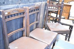 A set of four Victorian mahogany dining chairs having bobbin turned rail backs and brown leather