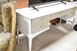 A 20th century white and grey painted dressing table, with an arrangement of five drawers, each with
