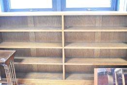 A solid golden oak double book shelf labelled Arthur W. Simpson, The Handicrafts, Kendal