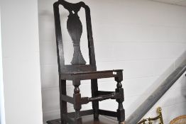 A 19th Century dark stained vase back dining chair having solid seat and turned support