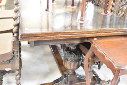 A mid to late 20th Century oak drawer leaf refectory style dining table having bulbous acorn