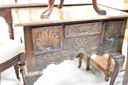 A period style oak low bow having carved drawer fronts and cabriole legs, approx. W78 D48 H71cm