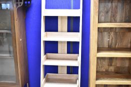 A modern laminate waterfall style bookshelf, height approx. 180cm