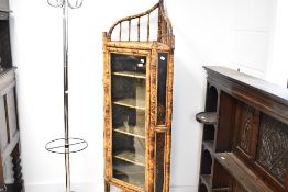 A traditional Chinese bamboo corner display cabinet of typical design, dimensions approx. H158cm,