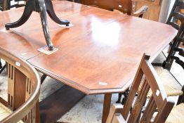 A late 19th or early 20th Century double gateleg dining table , having canted top and solid frame,