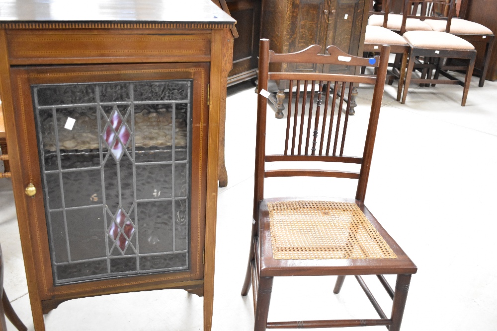 An Edwardian mahogany side cabinet having line inlay decoration, with leaded glass doors and