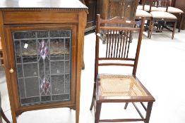An Edwardian mahogany side cabinet having line inlay decoration, with leaded glass doors and