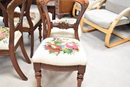 A set of four Victorian mahogany balloon back dining chairs having later tapestry foliate decoration