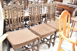 A set of six late 19th or early 20th Century dining chairs in the Carolean style with foliate carved