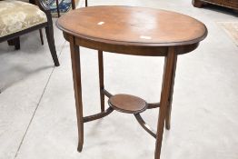An Edwardian mahogany occasional table having line inlay decoration with oval top and undertier,