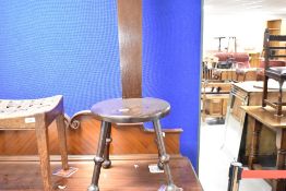 A traditional dark stained spinning chair with clover motif to back, seat height approx. 34cm