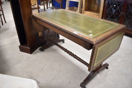 A reproduction Regency sofa style coffee table having drop flap ends and turned support on claw feet