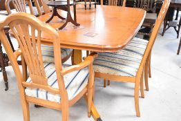 A nice quality modern yew effect extending dining table and set of six (four plus two) similar
