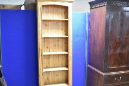 A modern pine narrow bookshelf, dimensions approx. H200 x W67 x D23cm