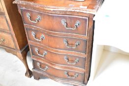 A reproduction dwarf chest of four serpentine fronted drawers, width approx. 48cm, height 72cm