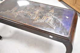 A 20th century Chinese carved hardwood coffee table, the rectangular top carved in relief with