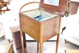An Edwardian mahogany sewing table having line inlay decoration and fitted interior, on square