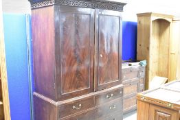A 19th Century mahogany linen press/wardrobe having dentil cornice and blinf fret frieze, with two