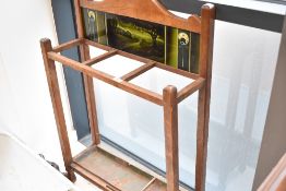 An early 20th century Arts & Crafts style stick/umbrella stand, the double arched back with inset