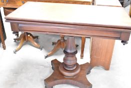 A 19th Century mahogany fold over tea table, in the William IV design, having turned column
