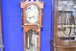A reproduction longcase clock , having 31 day movement and decorative brassed dial, named for