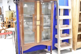 An Art Nouveau mahogany display cabinet having typical inlaid decoration in the Liberty's/Shapland