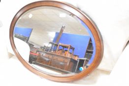 An Edwardian mahogany oval wall mirror , approx. 84 x 54cm