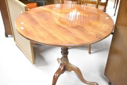 A 19th Century mahogany pedestal table having circular snap top, on turned column and triple splay
