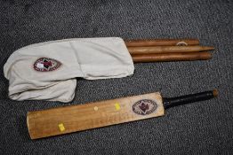A vintage The Foster Brewing Company Limited wooden cricket bat and wicket set, with original fabric