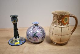 A 20th-century Gouda Holland ceramic candlestick, featuring colourful foliate and scrollwork motifs;