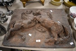 A large late 20th-century decorative stone wall relief panel, depicting sparring stallions,