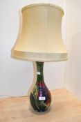 A 20th-century Moorcroft Pottery 'Hibiscus' lamp base, featuring colourful tube-lined floral