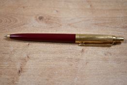 A Parker 45 ballpoint pen in red with gold reeded cap