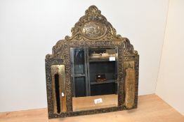 An early 20th-century Dutch-style brass-mounted mirror and brush set, featuring an arched top, a