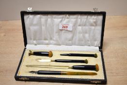 An early 20th-century Art Deco-style bakelite writing set, to feature a letter opener, dip pen,
