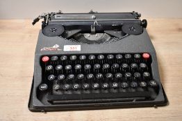 A mid 20th-century Empire Aristocrat portable manual typewriter, marked to front, 28cm x 28cm,