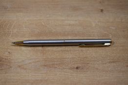 A Sheaffer Targa 1001x Brushed Steel with gold trim ballpoint pen