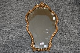 A vintage Atsonea gilt resin wall mirror, featuring an ornate Rococo-style frame with rose-formed