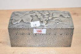 A 20th-century Arts and Crafts-style pewter mounted sandwood cigarette box, featuring an embossed