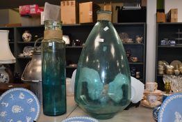 Two large contemporary Spanish San Miguel recycled glasswares, to feature a carboy-style example,