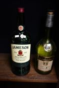 Two large vintage spirit bottles, both empty, comprising a J&F Martell VS Cognac and a Jameson Irish