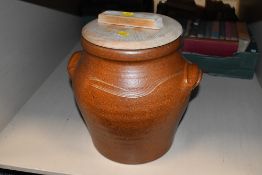 A large 20th-century stoneware confit pot, having a light wood lid and moulded twin handles with a