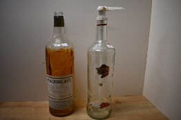 Two large vintage spirit bottles, both empty, comprising a Mackinlay's Old Scotch Whisky and a
