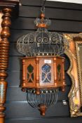 A vintage Moroccan-style metal hanging lantern, featuring a hand crafted bird cage-like top, a